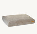 Coussin Senso MiaCara en bouclé coloris greige, vue trois quarts – Maison Canisya