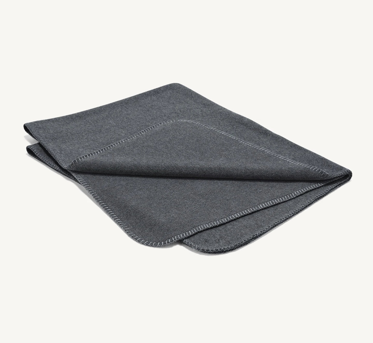 Couverture Unica – polaire chinée caillou pliée sur fond neutre – Maison Canisya