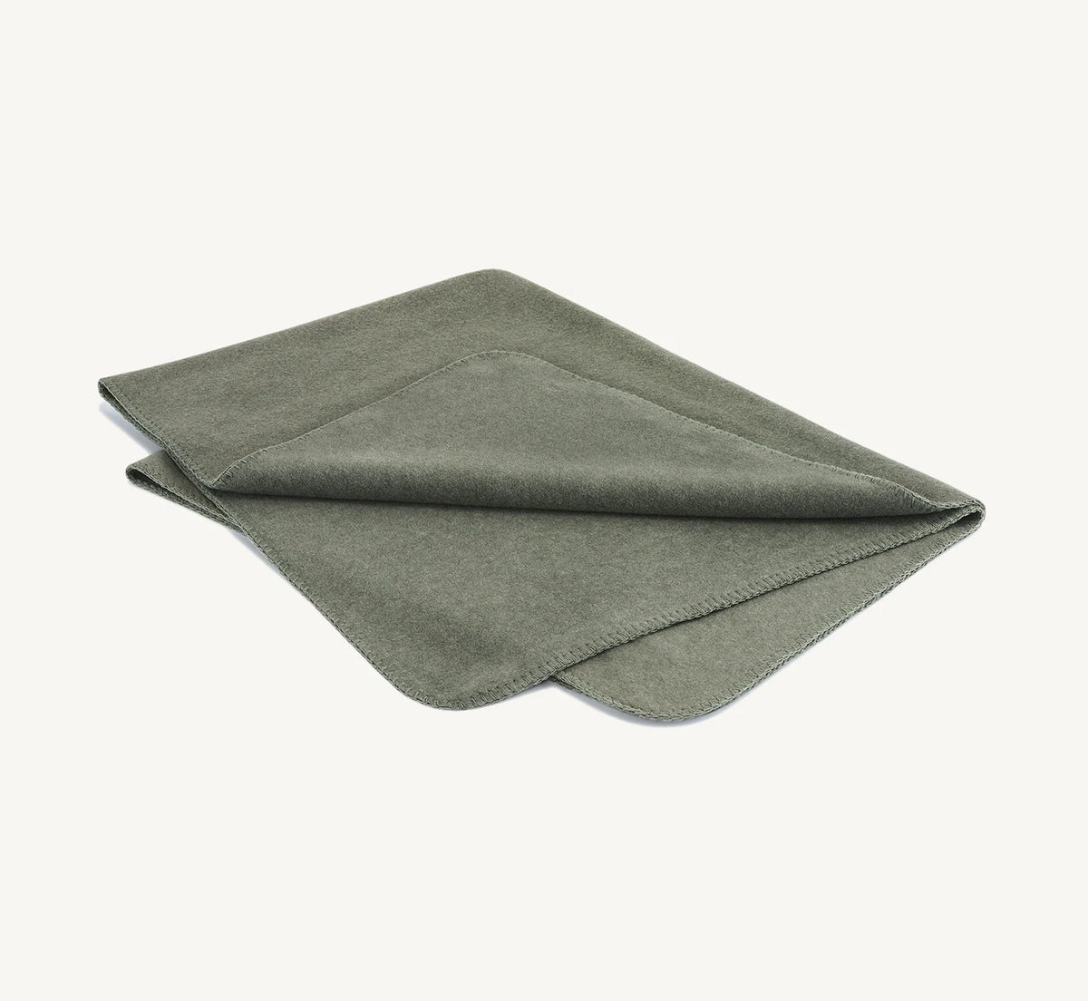 Couverture Unica – polaire chinée sage pliée sur fond neutre – Maison Canisya